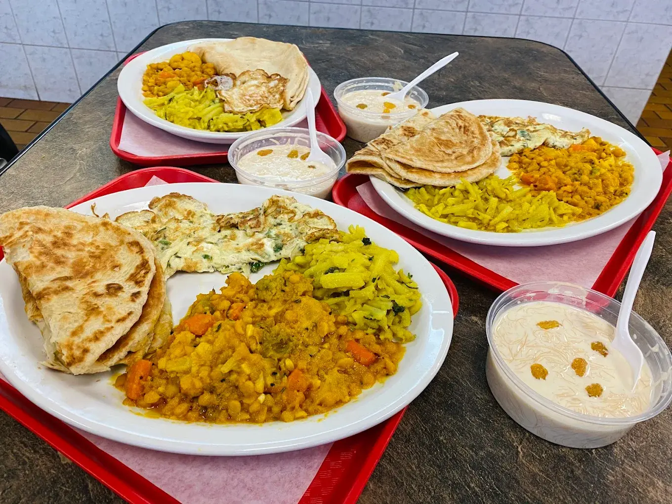 Halal platters with paratha, curry and seasoned rice at Donair and Poutine House in Edmonton, AB