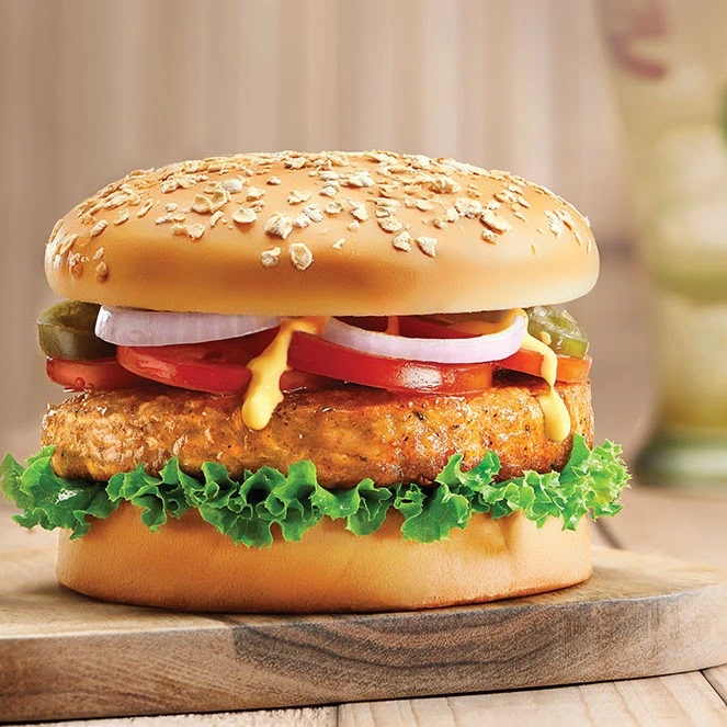 Gourmet burger stacked with fresh toppings at Donair and Poutine House in Edmonton, AB